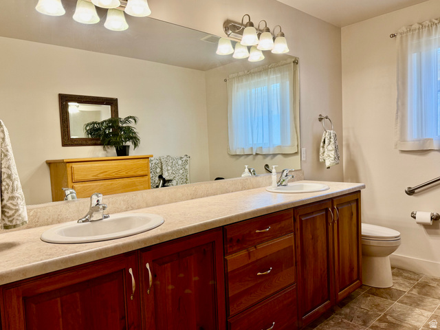 1204 South 1150th Street West Payson, UT 84651 - Photo 8 of 26 Master Bathroom with dual vanity with integrated sinks and warm wood-finish cabinetry