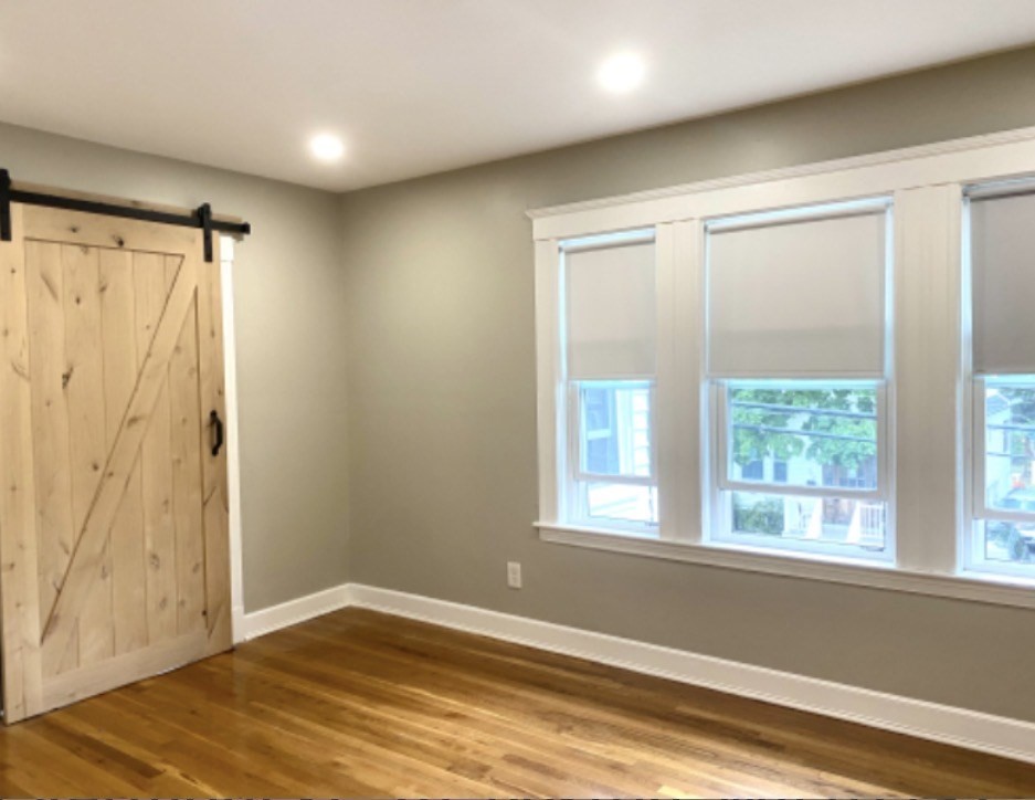 347 Vermont Street, Unit 2B Boston, MA 02132 - Photo 4 of 14 a view of empty room with wooden floor and fan