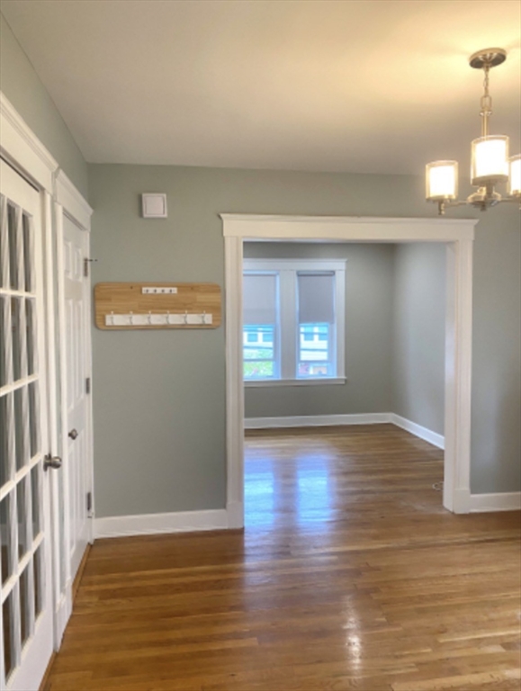 347 Vermont Street, Unit 2B Boston, MA 02132 - Photo 5 of 14 a view of an empty room with wooden floor and a window