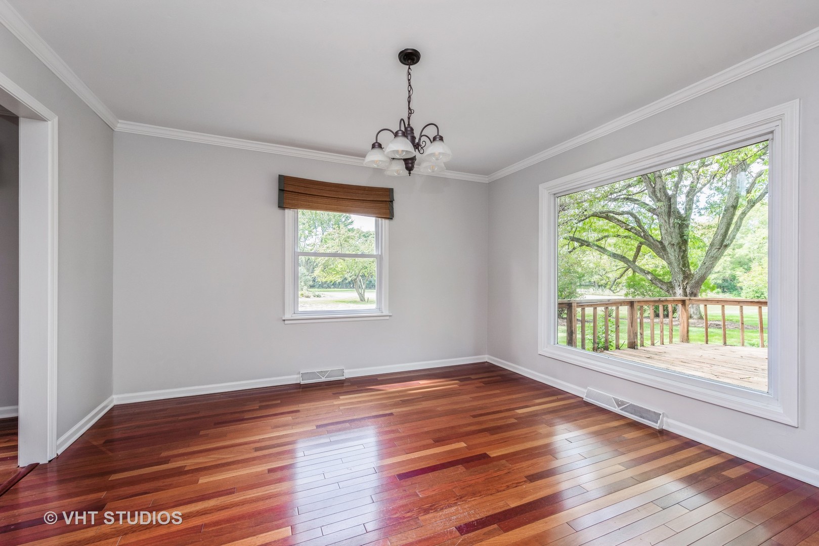 238 Valley Road Trout Valley, IL 60013 - Photo 8 of 41 a view of an empty room with wooden floor and a window
