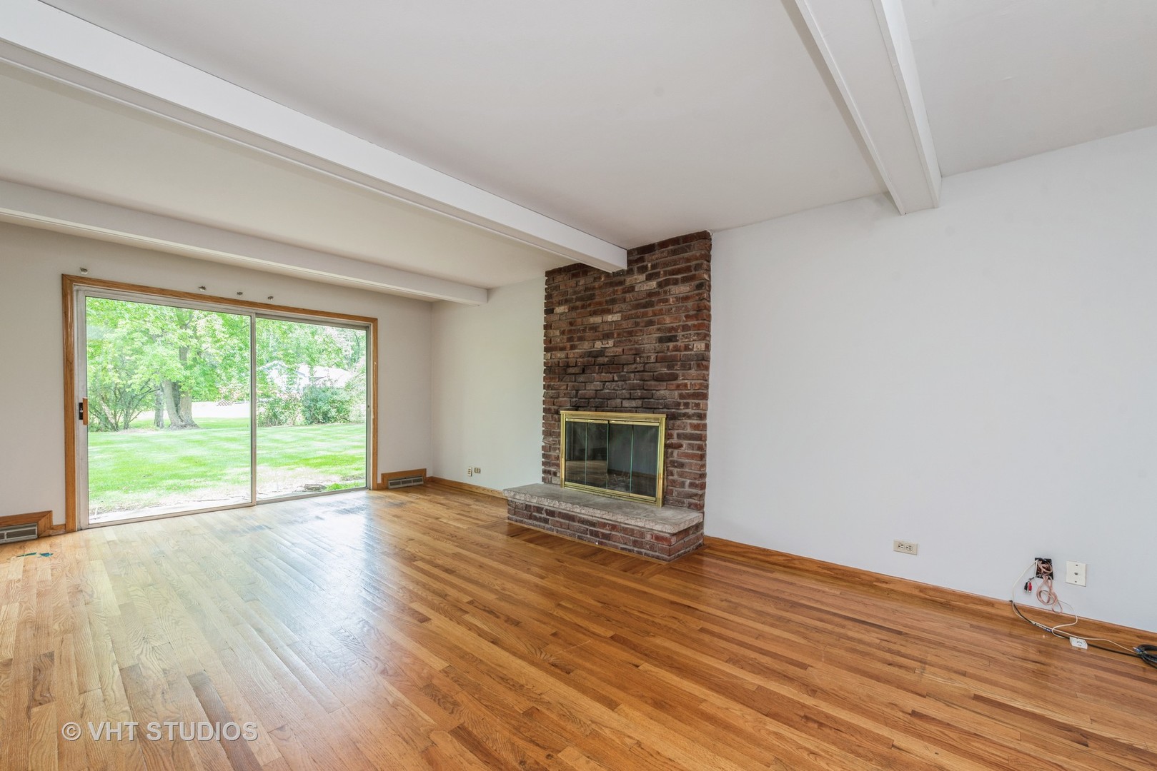 238 Valley Road Trout Valley, IL 60013 - Photo 9 of 41 a view of empty room with wooden floor and fireplace