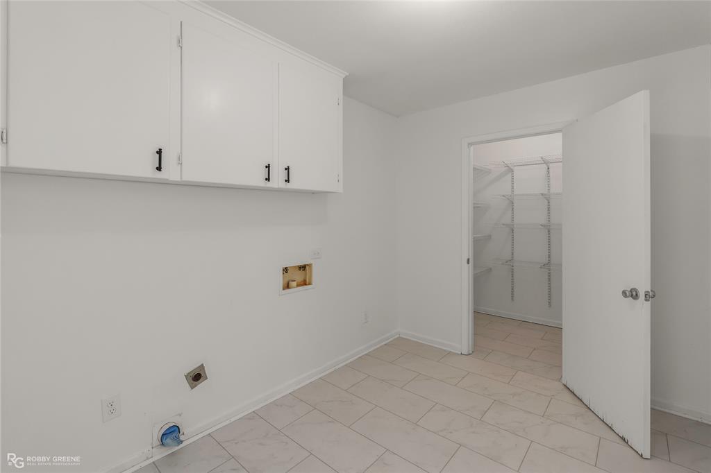 1303 Young Road Benton, LA 71006 - Photo 16 of 34 Laundry room with washer hookup, cabinet space, light marble finish flooring, and hookup for an electric dryer