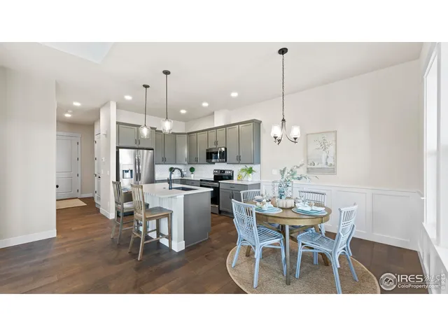 a living room with stainless steel appliances kitchen island granite countertop furniture and a dining table