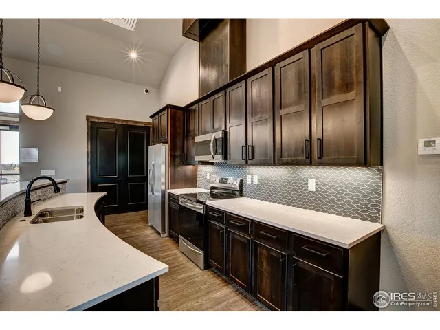 a kitchen with a sink counter top space and stainless steel appliances