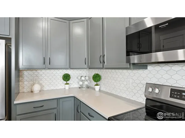 a kitchen with a sink a microwave and cabinets