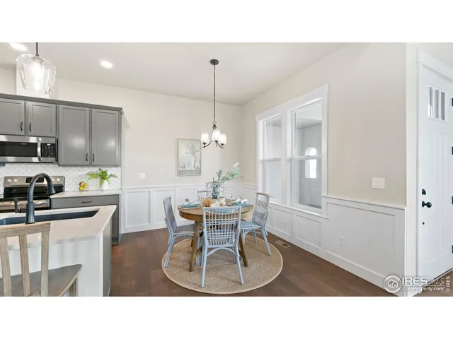 a kitchen with a table chairs refrigerator and cabinets