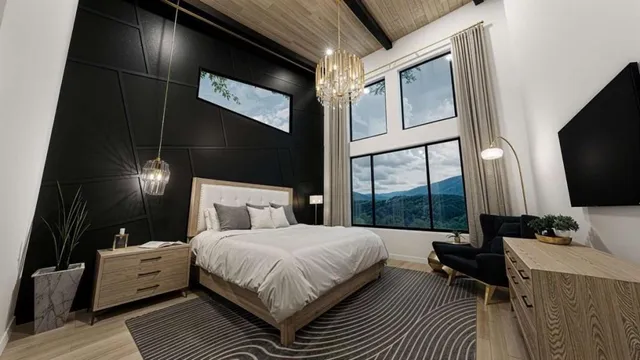 a bedroom with a bed window and a flat screen tv