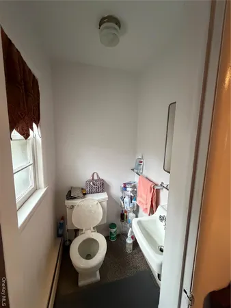 a bathroom with a sink mirror and toilet