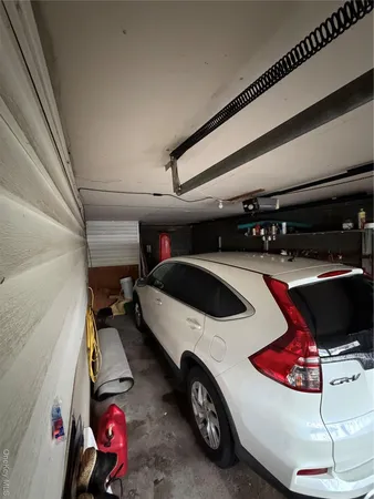 a living room with furniture gym equipment and a mirror