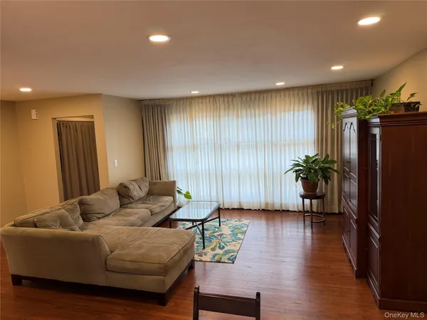 a living room with furniture and a hard wood floor