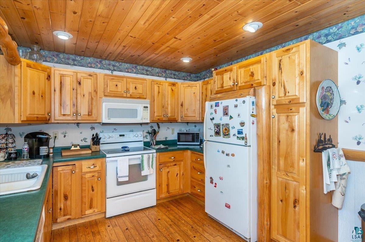 11758 South Long Lake Road Solon Springs, WI 54873 - Photo 10 of 38 Kitchen featuring sink, light hardwood / wood-style floors, wooden ceiling, and white appliances