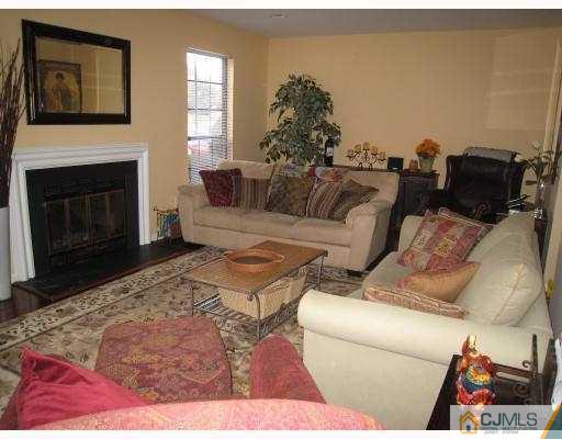 3305 Stonehedge Road Edison, NJ 08820 - Photo 2 of 10 a living room with furniture and a fireplace