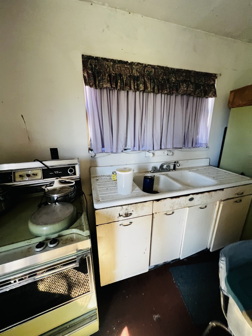 5266 South 12750E Road Pembroke Township, IL 60958 - Photo 10 of 17 a kitchen with a stove and a sink