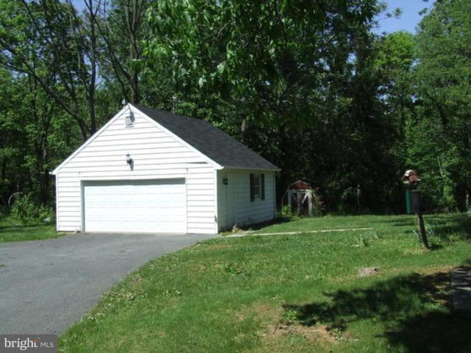 417 Mish Road Bunker Hill, WV 25413 - Photo 3 of 13 a view of a house with yard and tree s