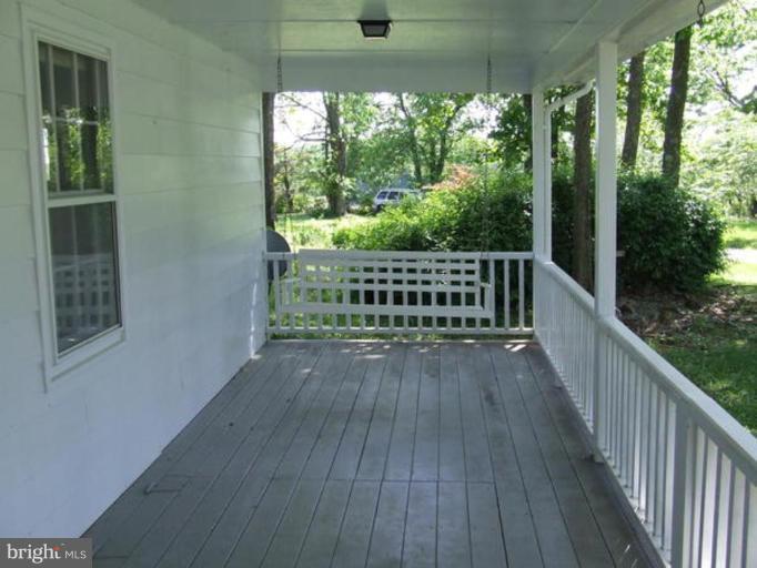 417 Mish Road Bunker Hill, WV 25413 - Photo 4 of 13 a view of a balcony with wooden floor