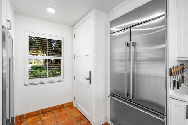 a view of a refrigerator and utility room in a kitchen