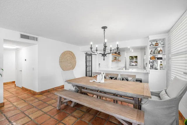 a living room with furniture a flat screen tv and a large window