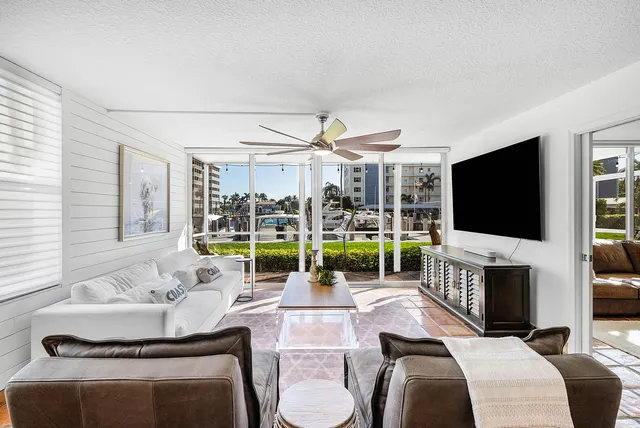 a living room with furniture and a floor to ceiling window