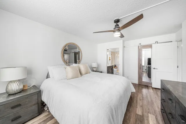 a bathroom with a double vanity sink toilet mirror and shower