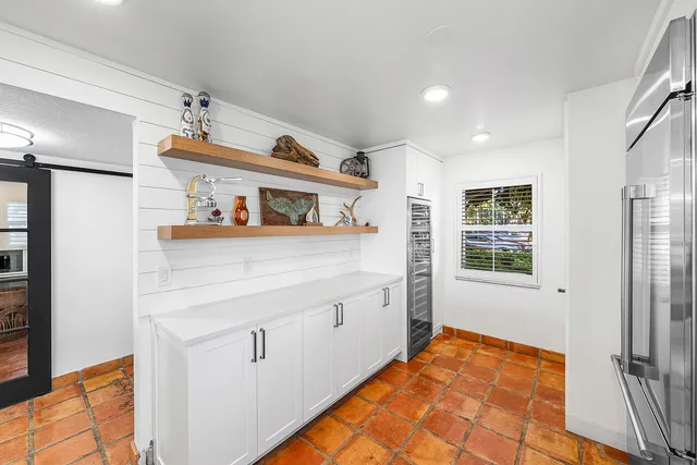 a kitchen with white cabinets and appliances