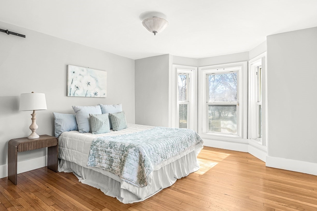 53 Lake Street Winchester, MA 01890 - Photo 16 of 36 a bedroom with a large bed and a window