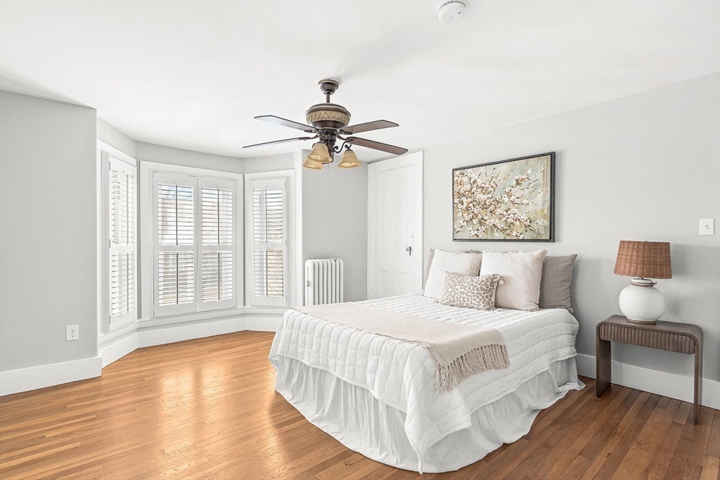53 Lake Street Winchester, MA 01890 - Photo 17 of 36 a bedroom with a large bed and a chandelier