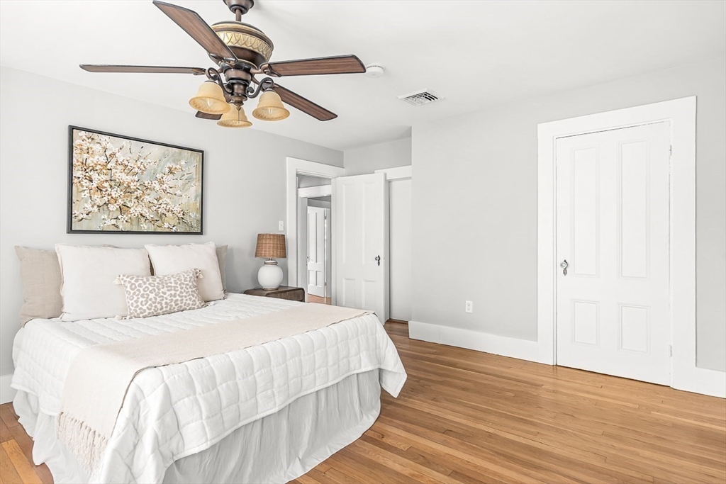53 Lake Street Winchester, MA 01890 - Photo 18 of 36 a bedroom with a bed and a chandelier