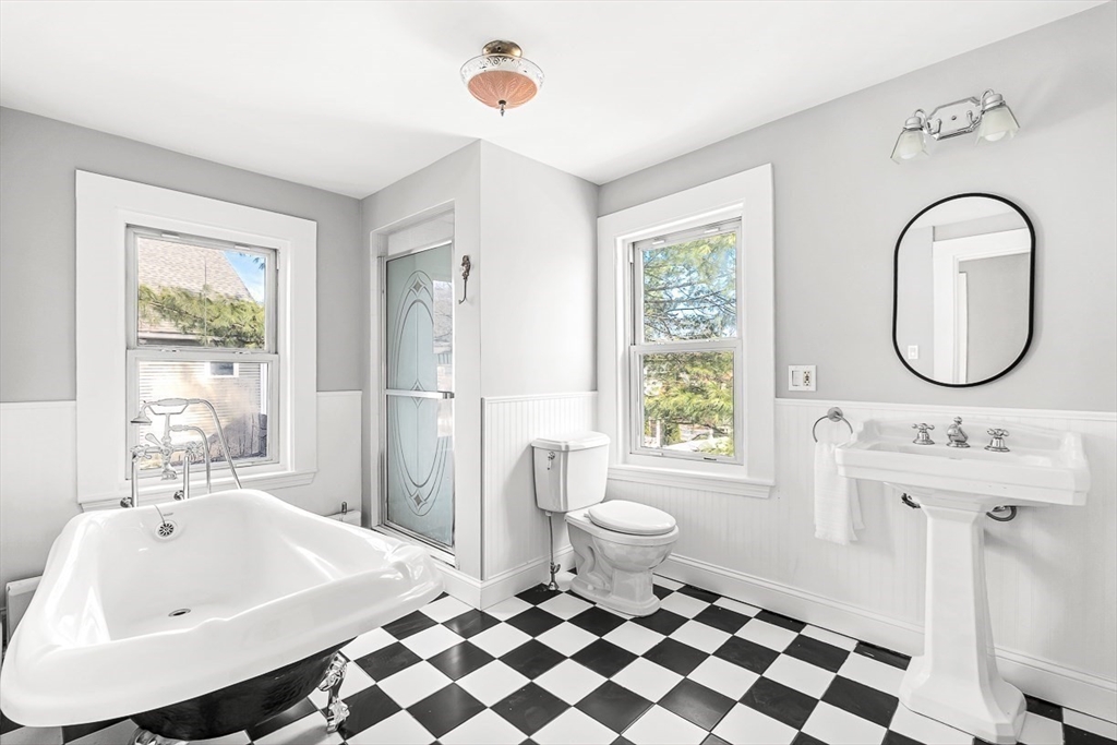 53 Lake Street Winchester, MA 01890 - Photo 20 of 36 a bathroom with a sink a toilet and a mirror