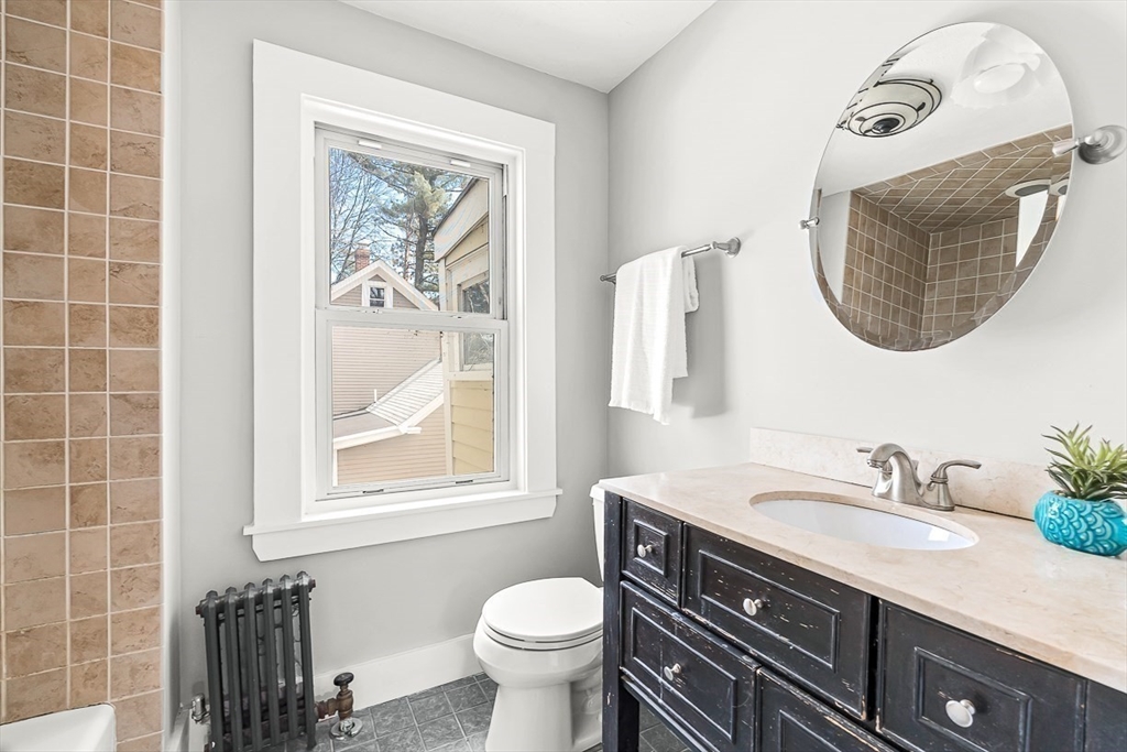 53 Lake Street Winchester, MA 01890 - Photo 23 of 36 a bathroom with a granite countertop toilet sink and mirror