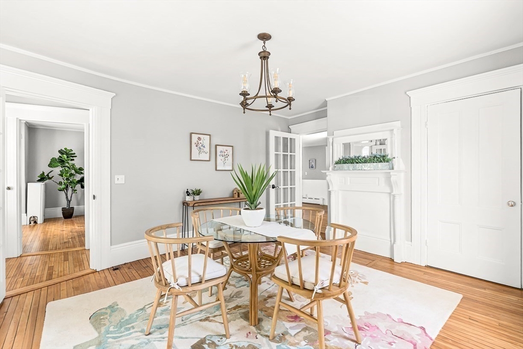 53 Lake Street Winchester, MA 01890 - Photo 9 of 36 a view of a dining room with furniture wooden floor and a chandelier