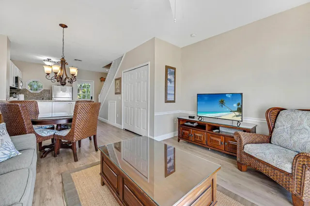a living room with furniture and a chandelier