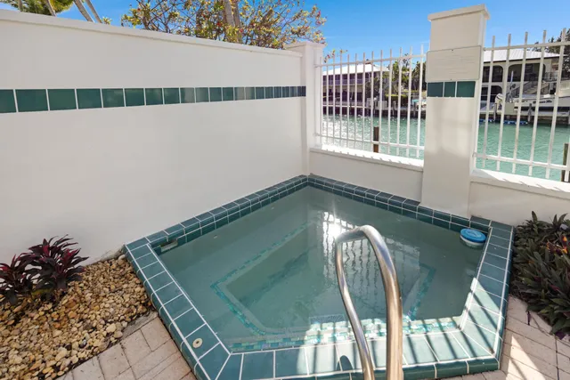 a view of balcony with chairs and potted plants