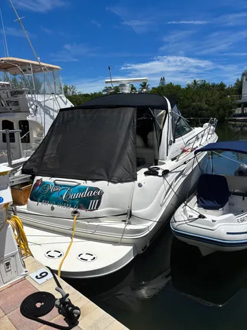 a roof deck with table and chairs