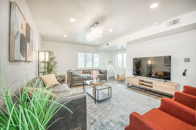 a living room with furniture and a flat screen tv