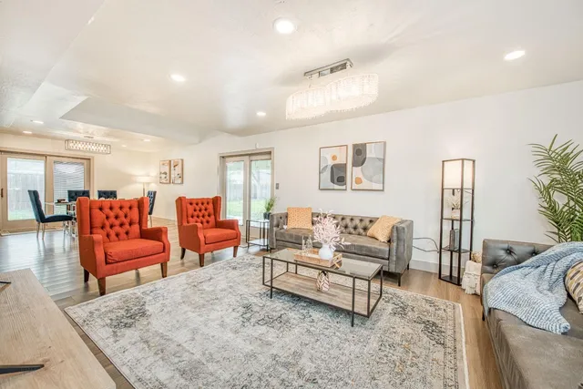 a living room with furniture and a potted plant