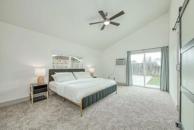 a bedroom with a large bed and a chandelier
