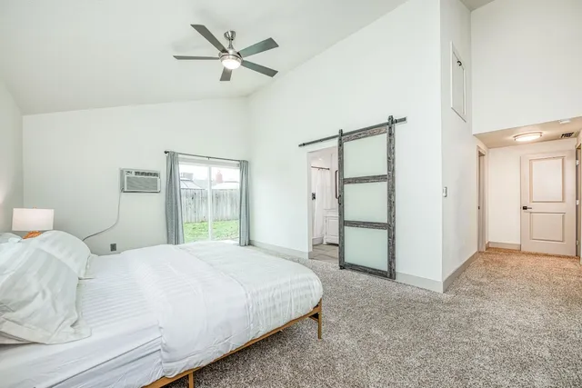 a bedroom with a bed and a ceiling fan
