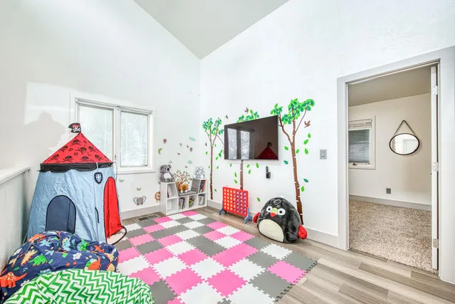 a bedroom with a bed and a tv