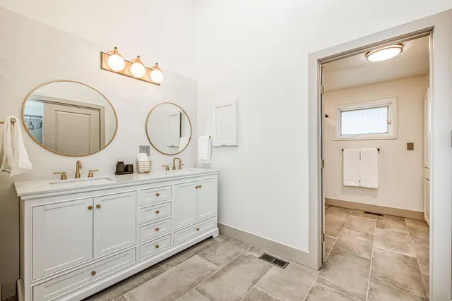 a view of bathroom with dual sinks