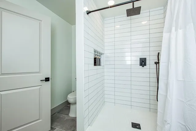 a bathroom with a shower and a toilet
