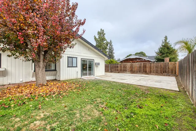 a view of a house with a yard and garage