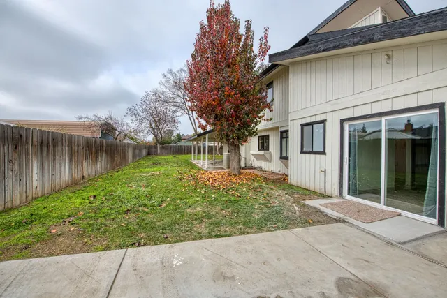 a front view of a house with a garden and plants