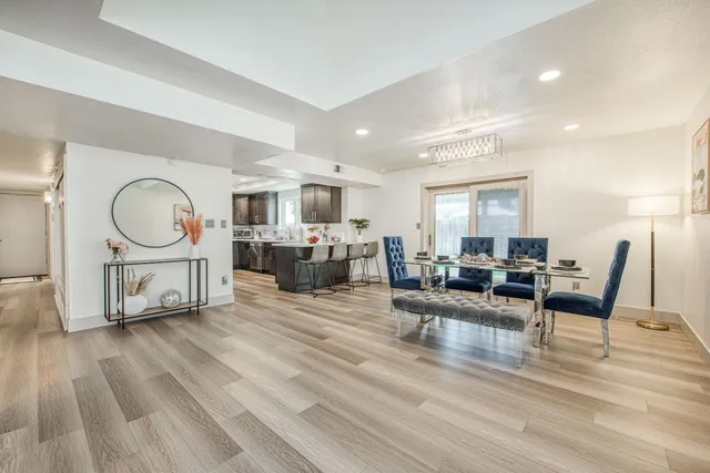a living room with furniture a mirror and a flat screen tv