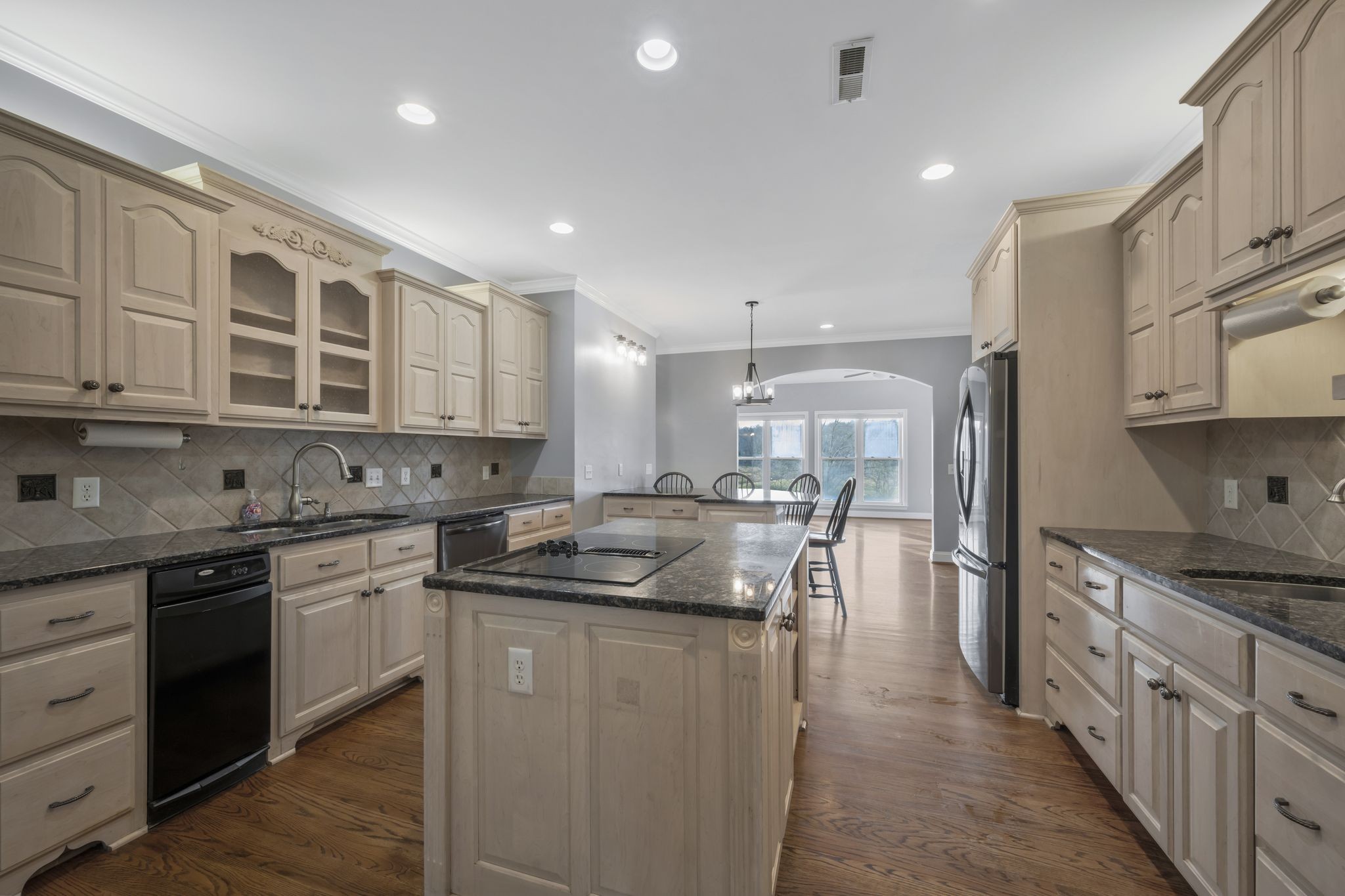 1053 Hall Cemetery Road Burns, TN 37029 - Photo 12 of 64 a kitchen with stainless steel appliances granite countertop a stove a sink and a refrigerator