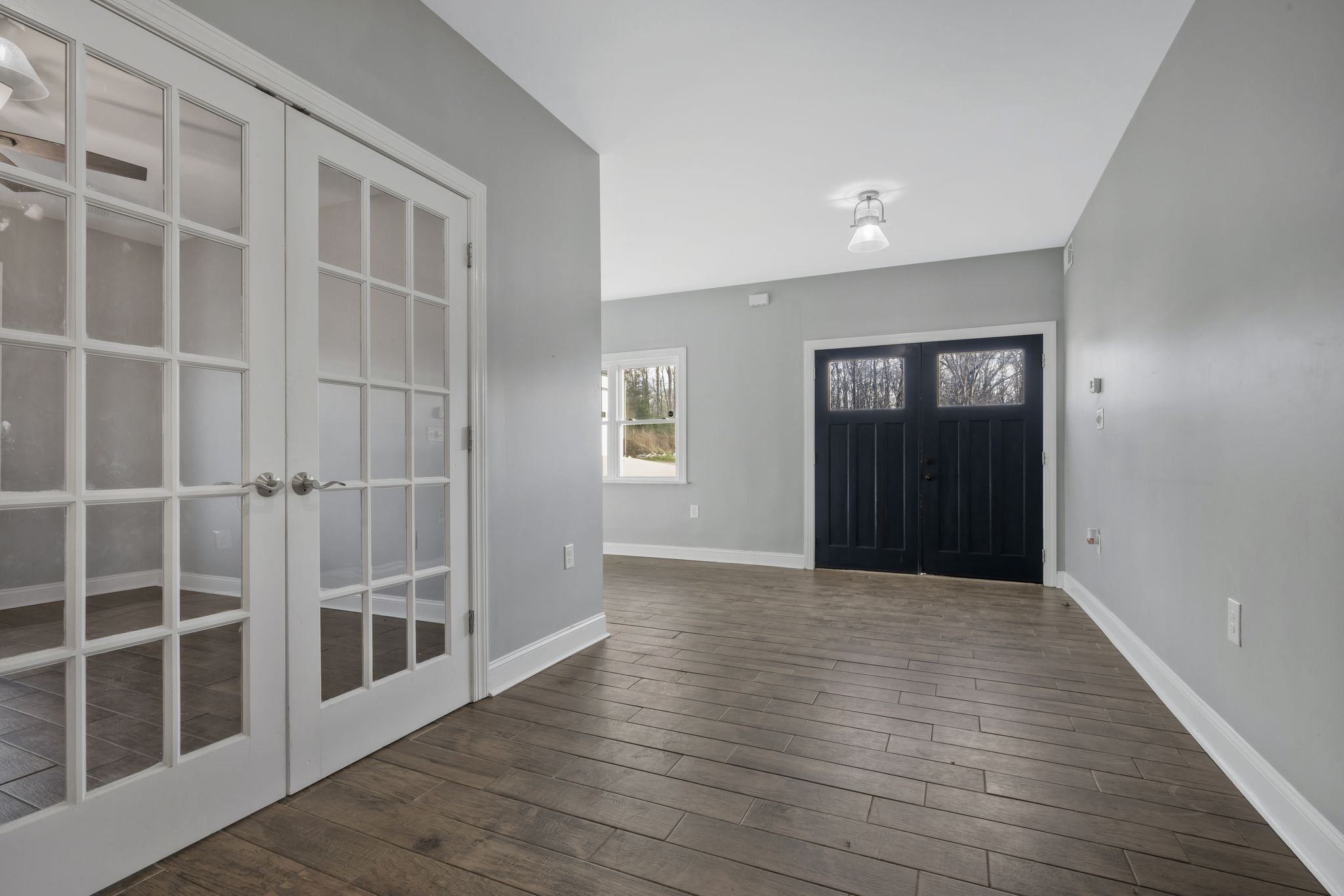1053 Hall Cemetery Road Burns, TN 37029 - Photo 17 of 64 a view of an empty room with wooden floor and a window
