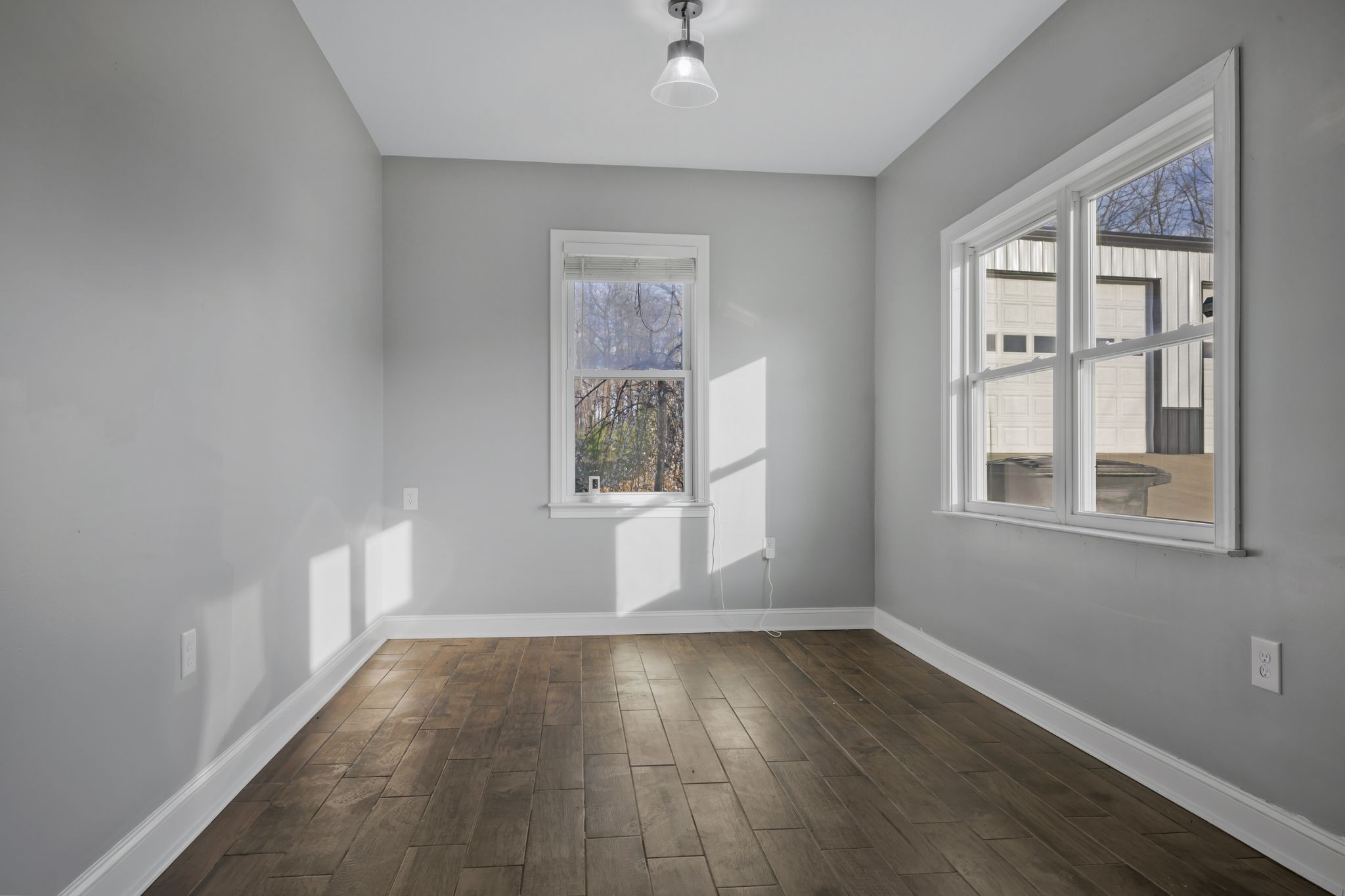 1053 Hall Cemetery Road Burns, TN 37029 - Photo 19 of 64 an empty room with wooden floor and windows
