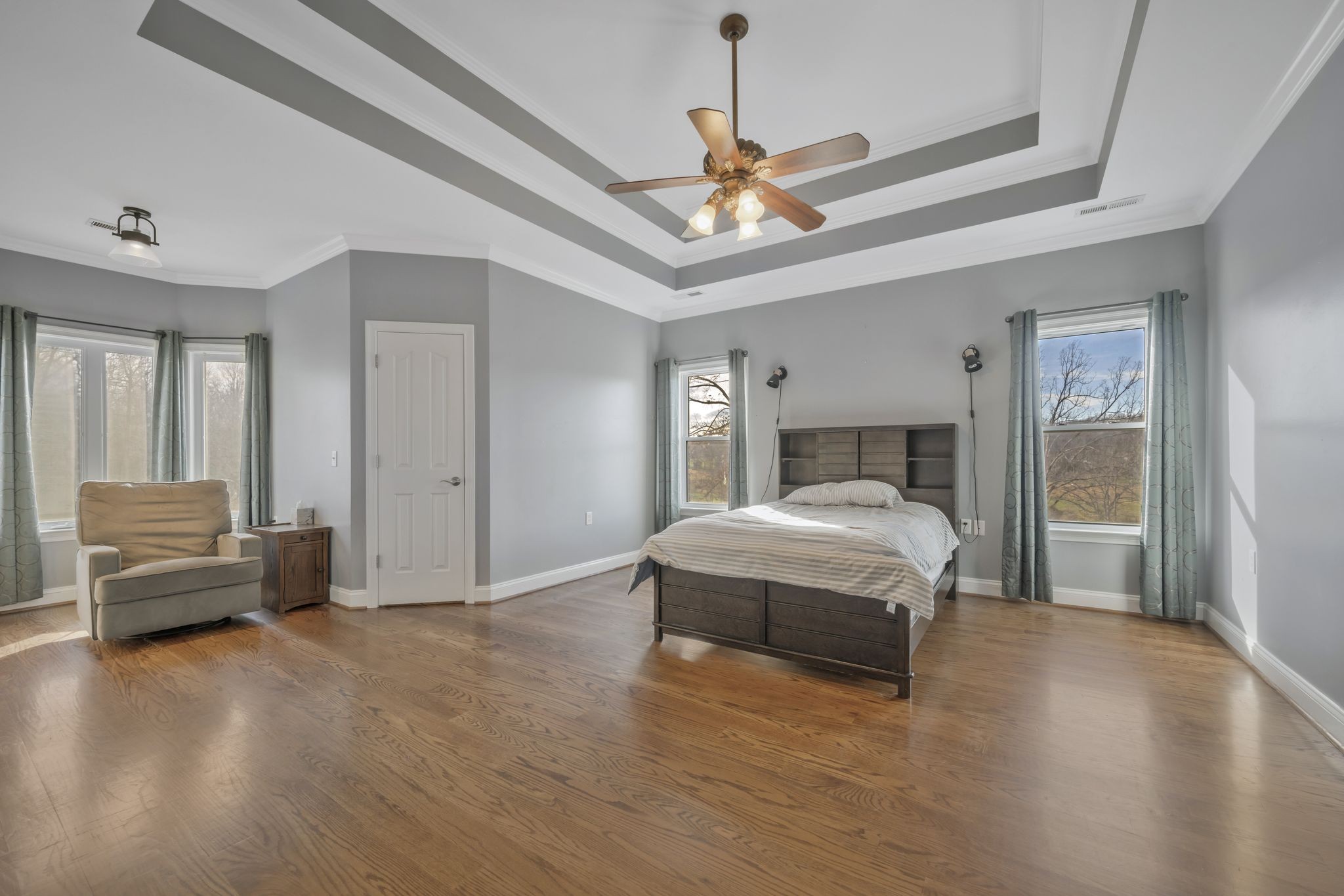 1053 Hall Cemetery Road Burns, TN 37029 - Photo 21 of 64 a spacious bedroom with a bed and a chandelier