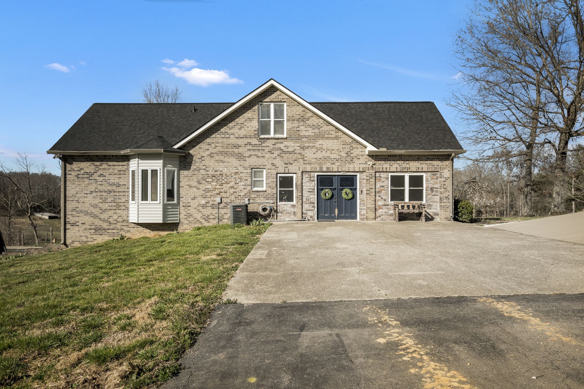 1053 Hall Cemetery Road Burns, TN 37029 - Photo 33 of 64 a front view of a house with a yard and garage