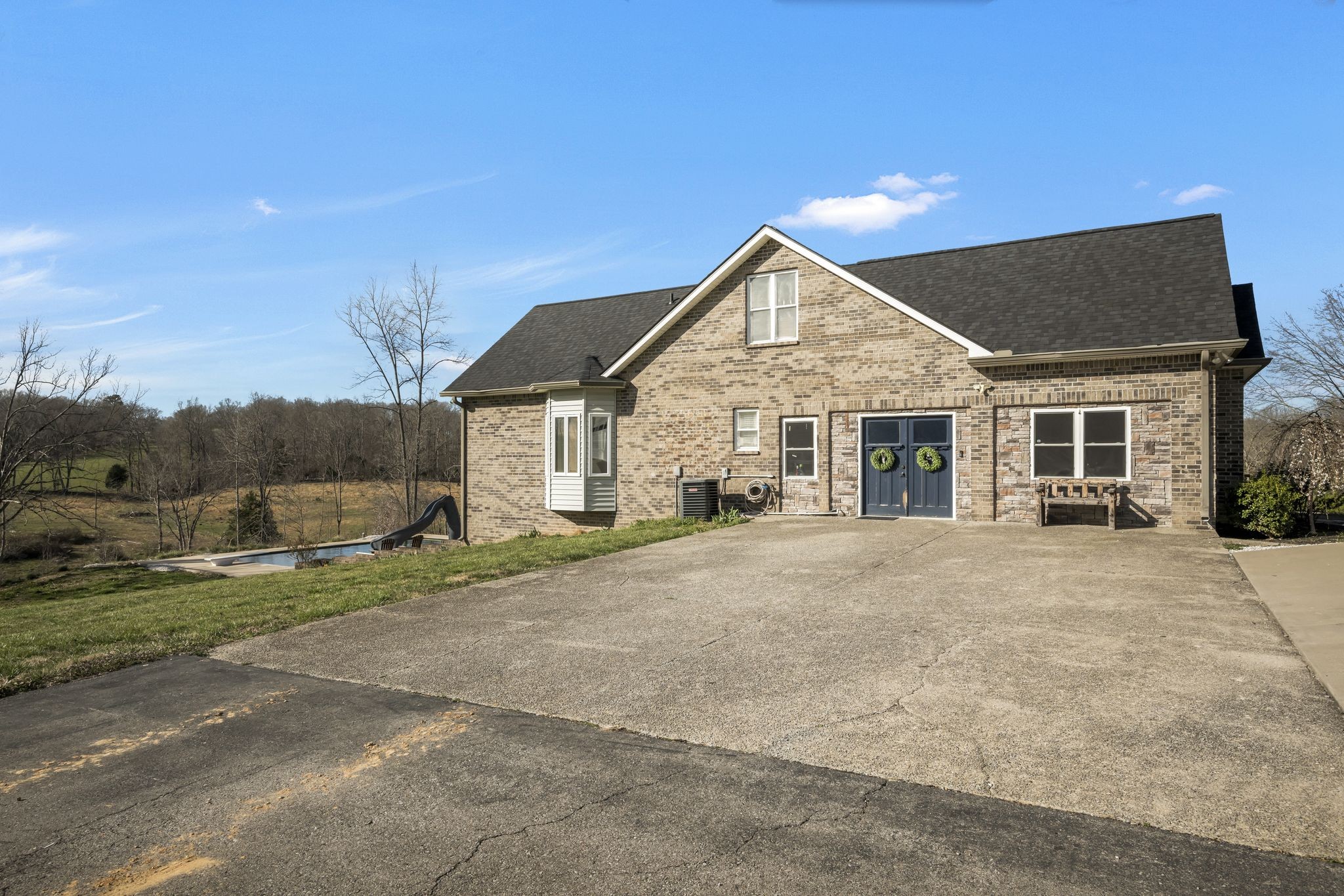 1053 Hall Cemetery Road Burns, TN 37029 - Photo 34 of 64 a view of a house next to a big yard with large trees