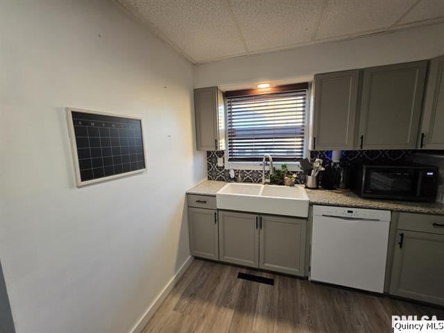 1431 Spruce Street Quincy, IL 62301 - Photo 13 of 36 a kitchen with sink cabinets and wooden floor